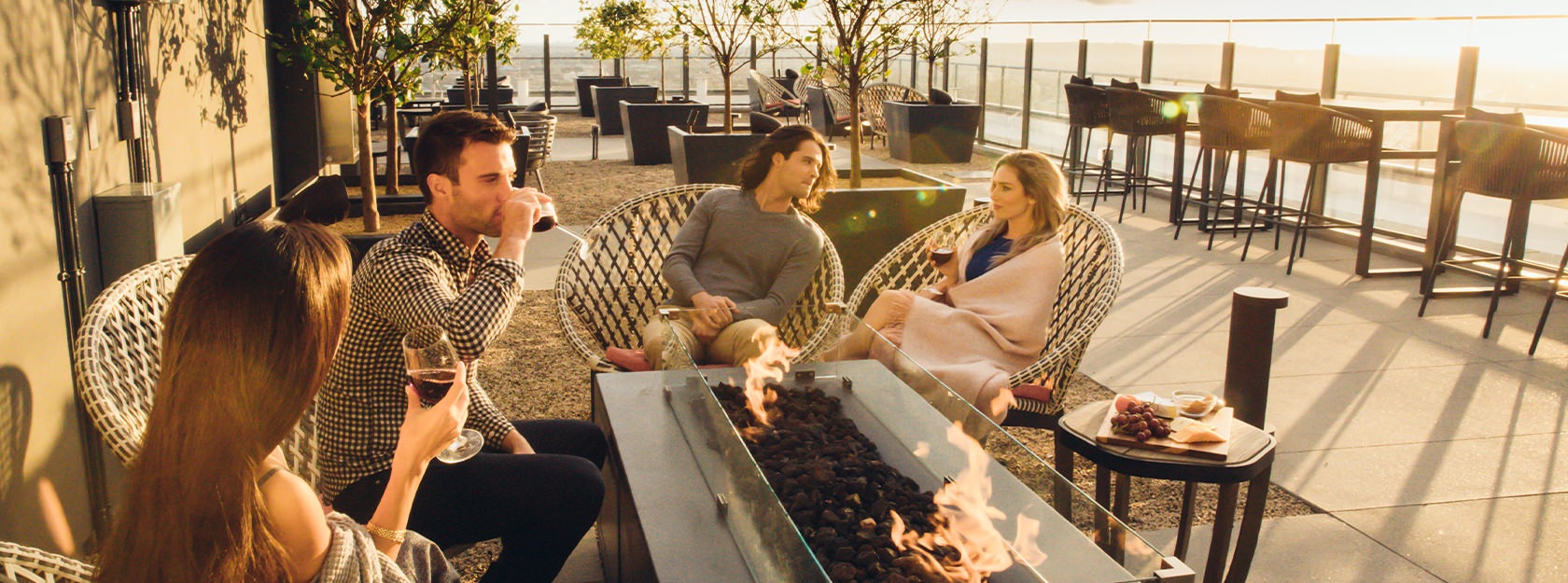 Friends sitting outside on a deck drinking wine