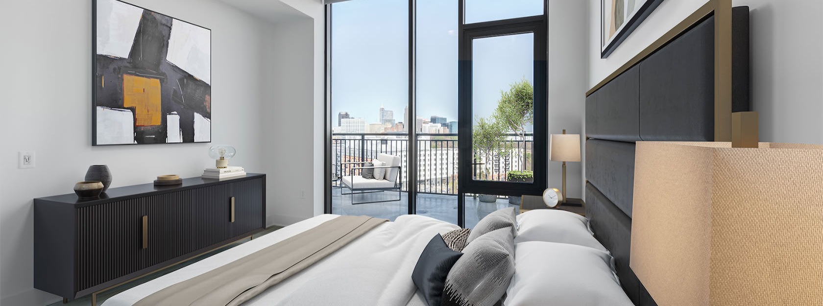 bedroom with large windows and private balcony views