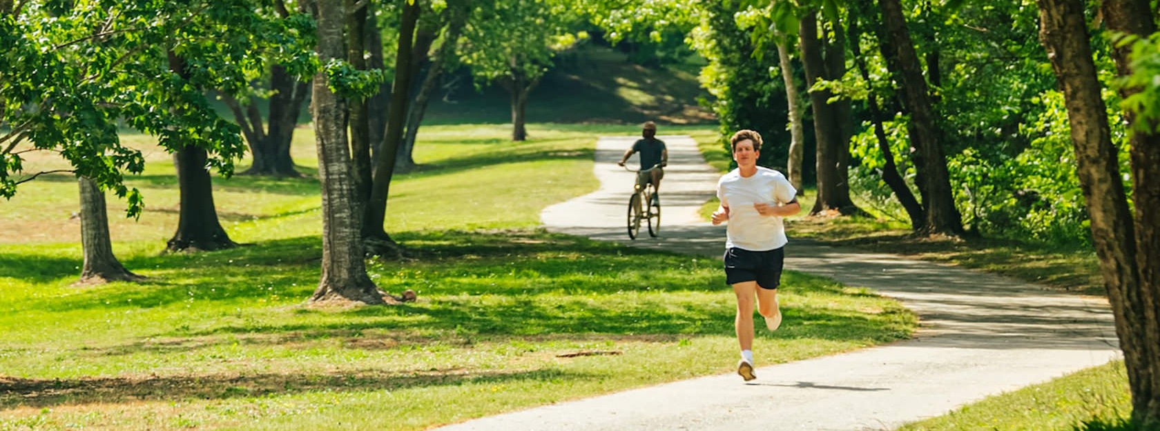 man runs through park